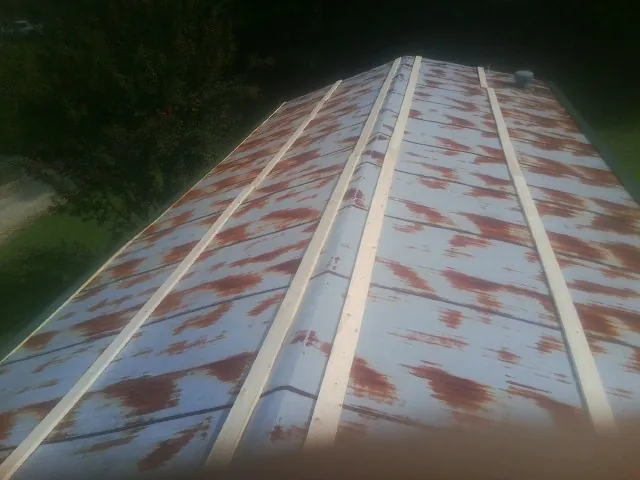 Rusted metal roof panels with new wood purlins before replacement — Storm Damage Roof Repair in Hubbardsville by Roofing Brothers